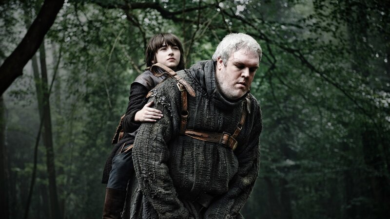 man carrying boy in forest
