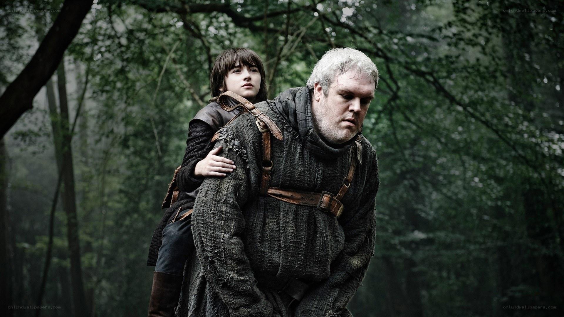 man carrying boy in forest