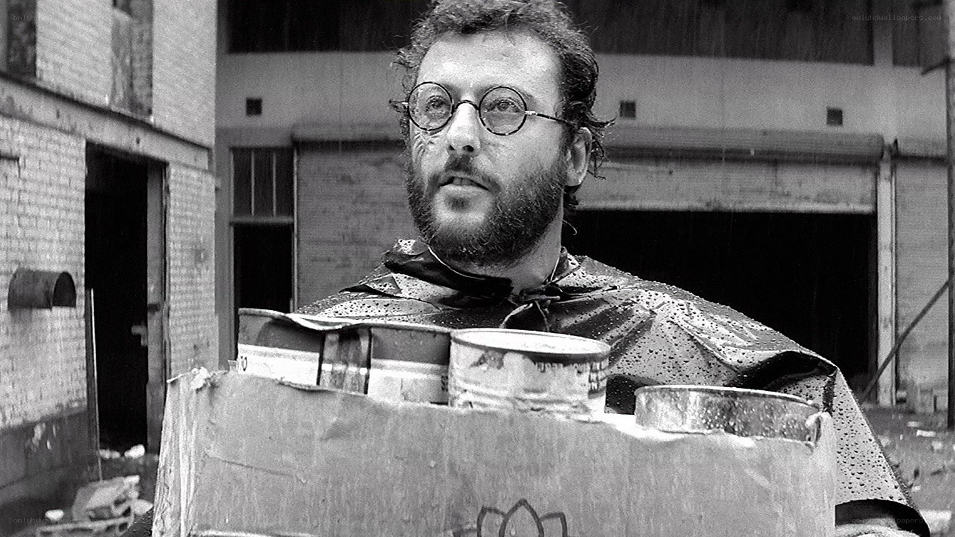 Man carrying cans in rain