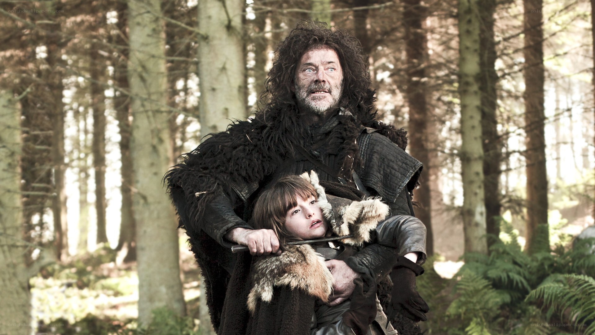 Man carrying child in forest