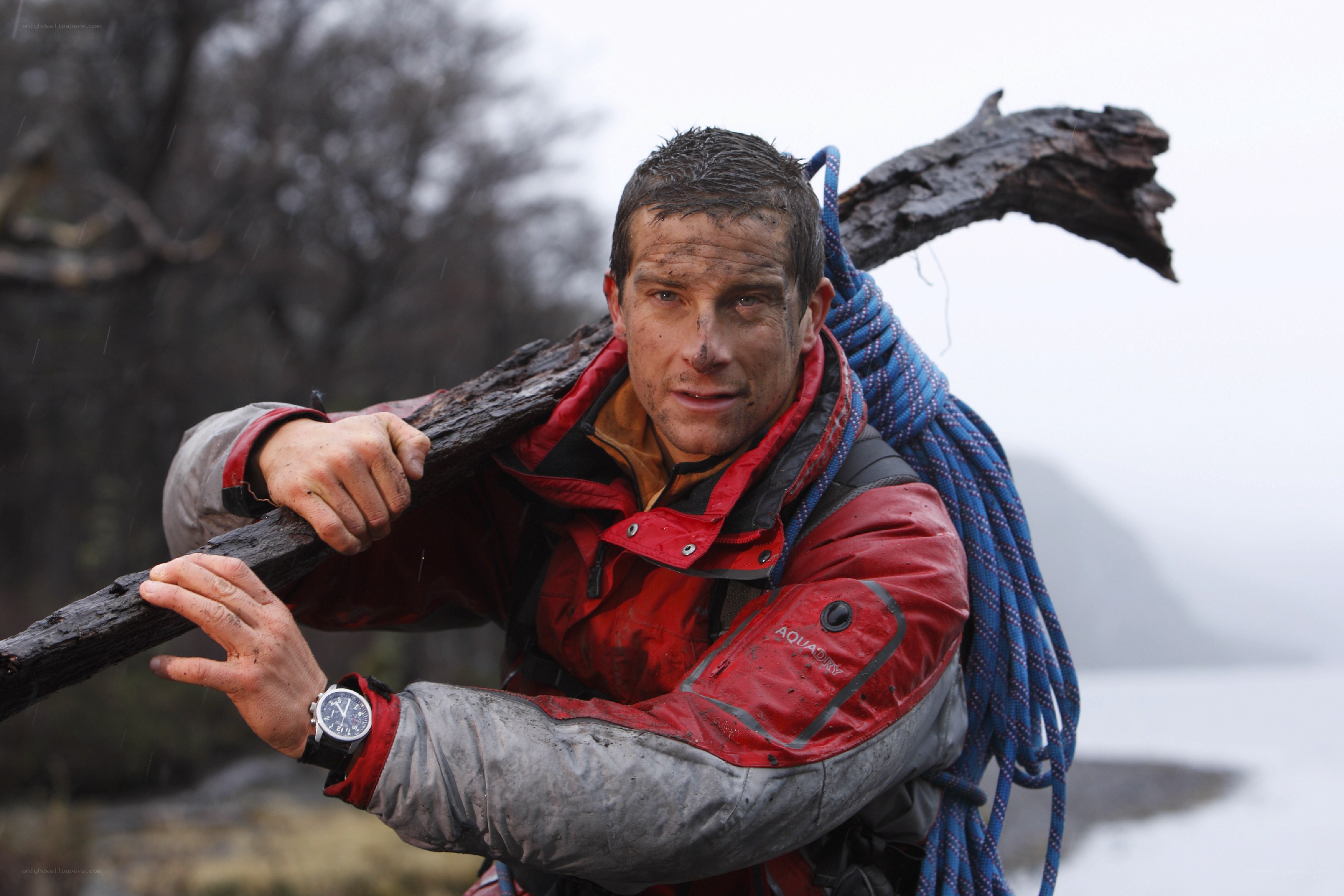 man carrying log in rain