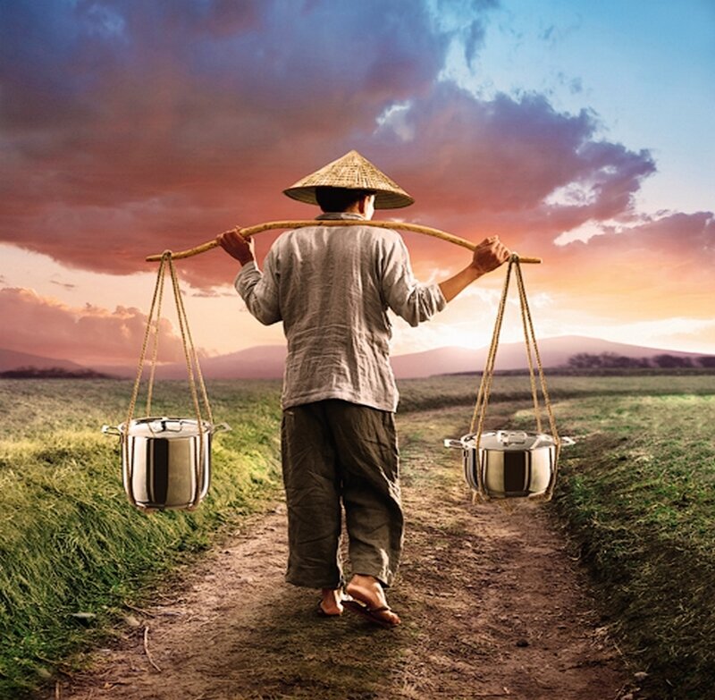 Man Carrying Pots on Pole