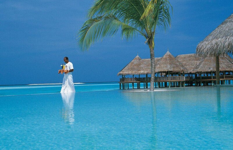 Man Carrying Tray in Pool