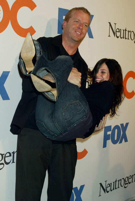 Man carrying woman at event