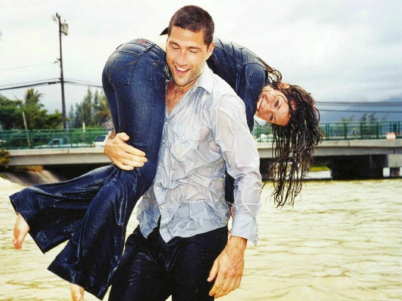 Man carrying woman in water