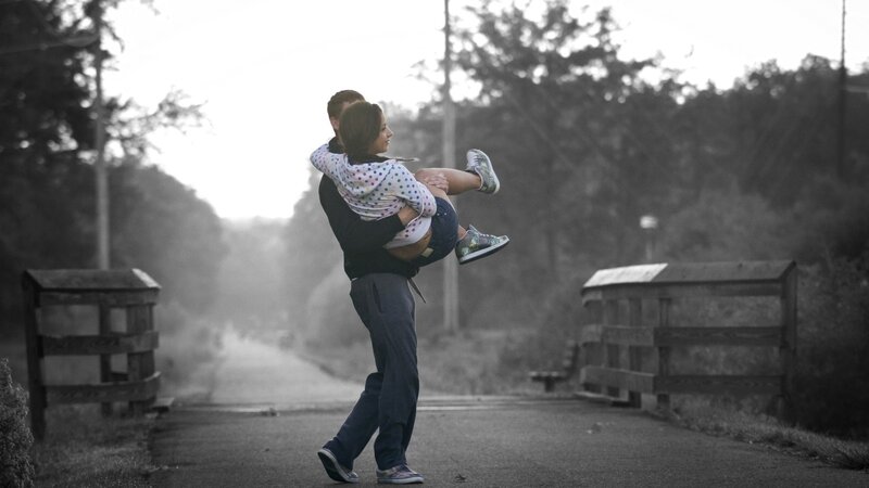 man carrying woman on road