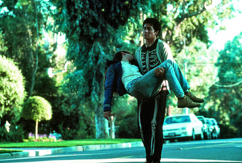 Man carrying woman on street