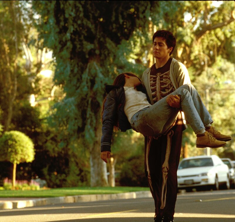 Man carrying woman on street