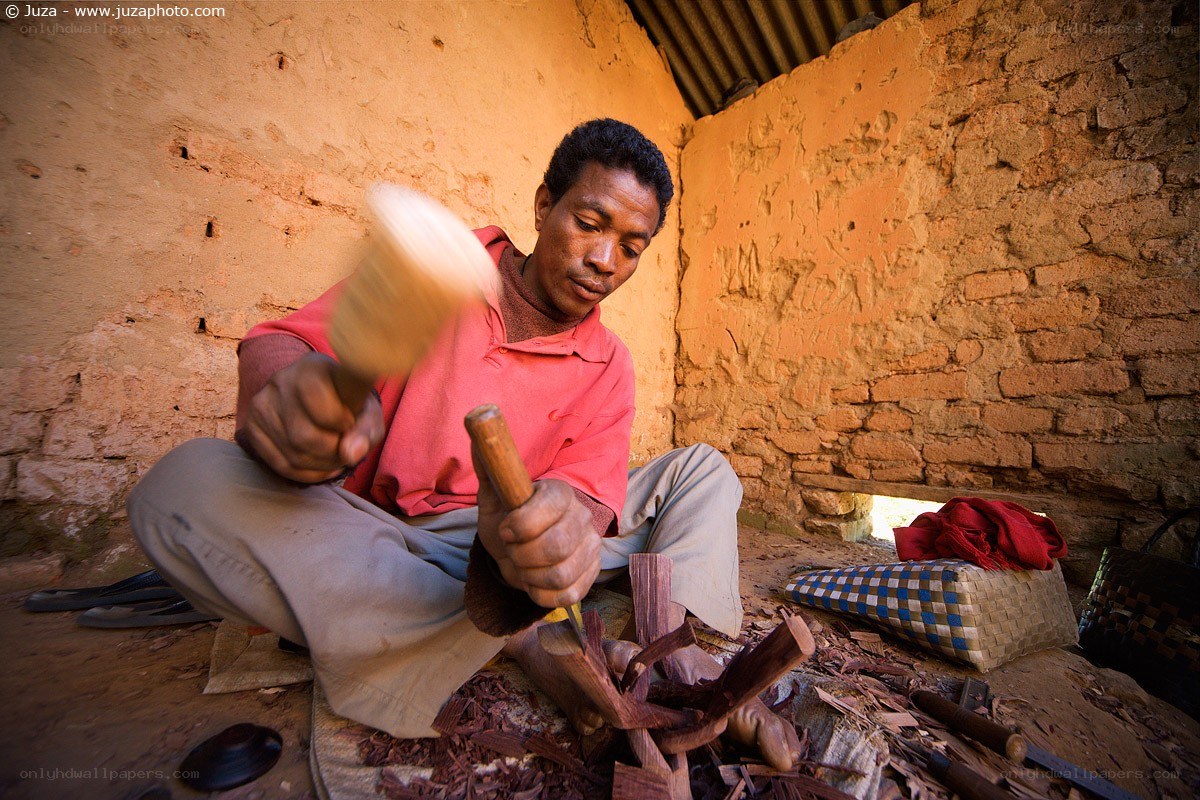 Man carving wood by hand