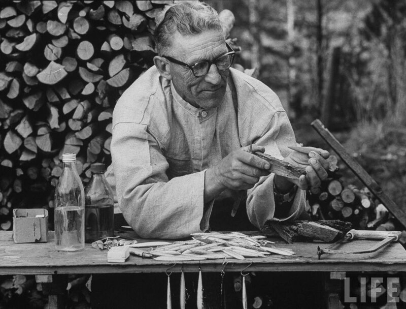 Man carving wood outdoors