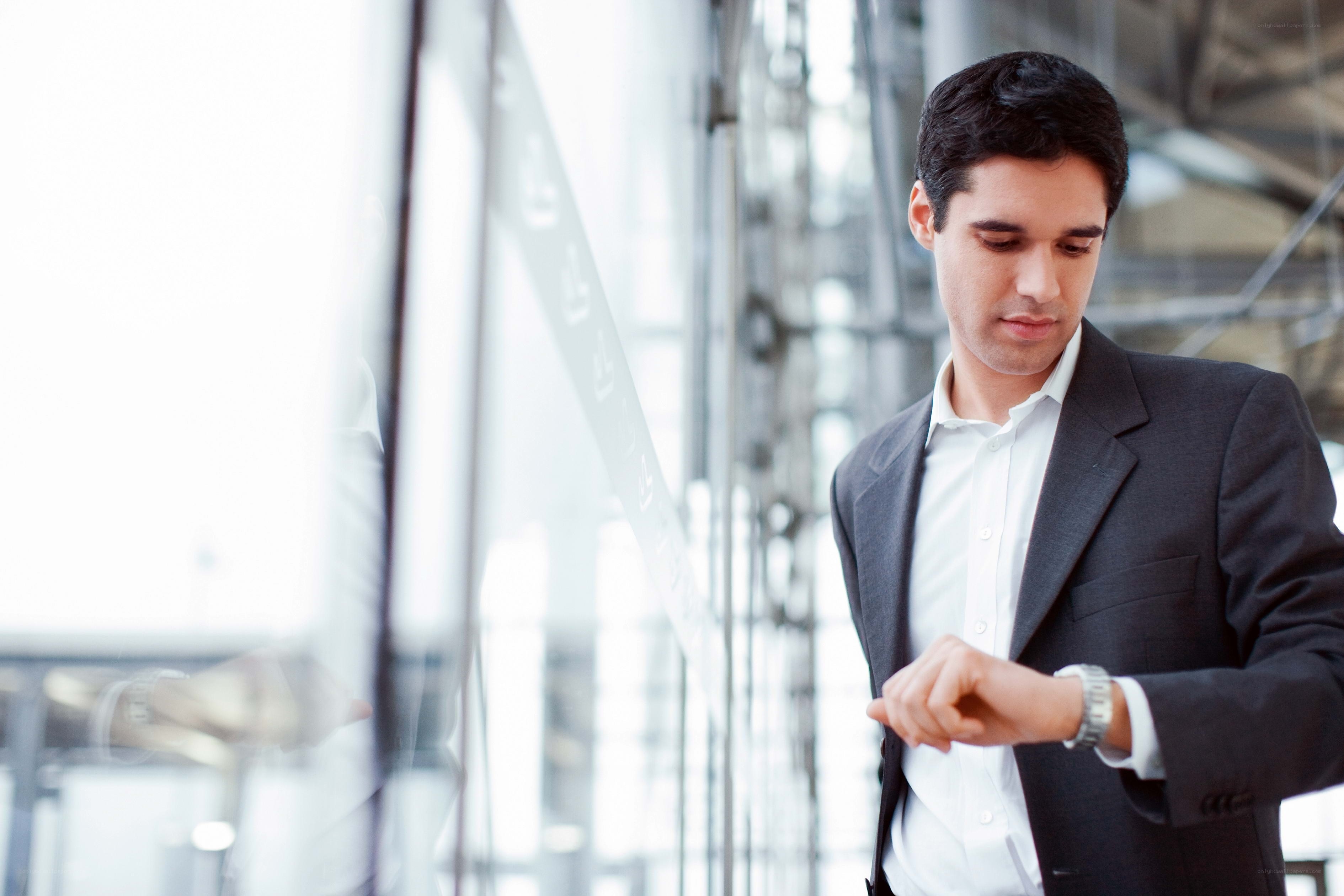 Man checking watch in office