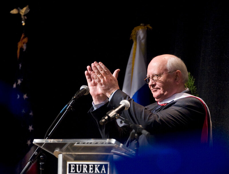 Man clapping at podium