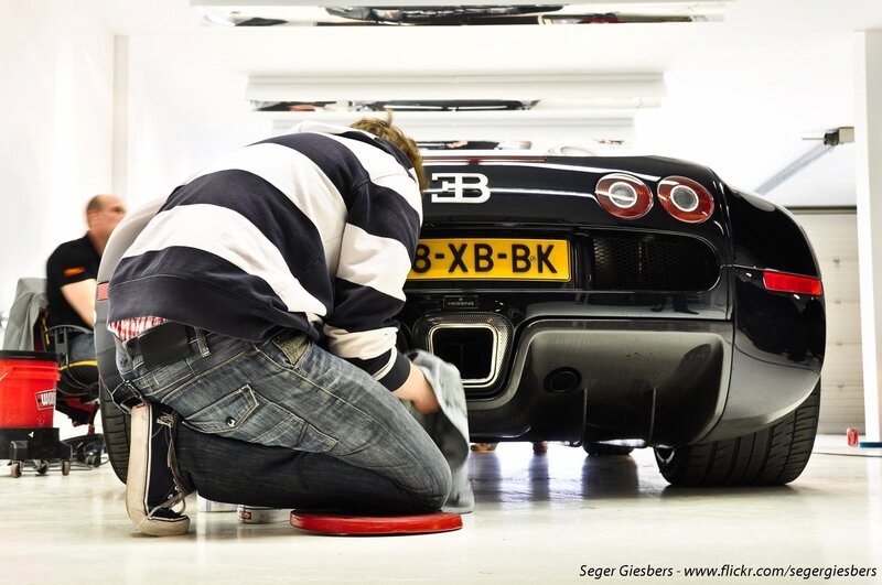 Man cleaning a Bugatti Veyron