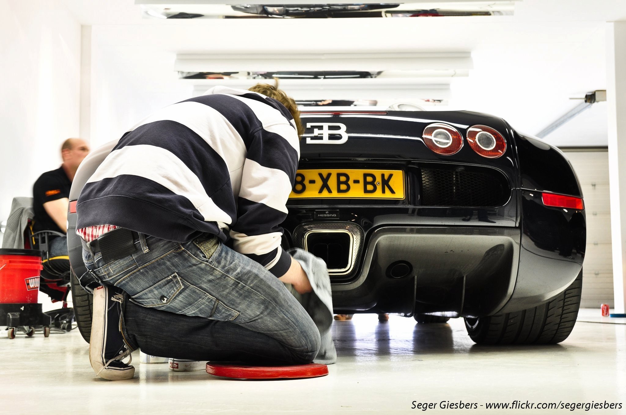 Man cleaning a Bugatti Veyron