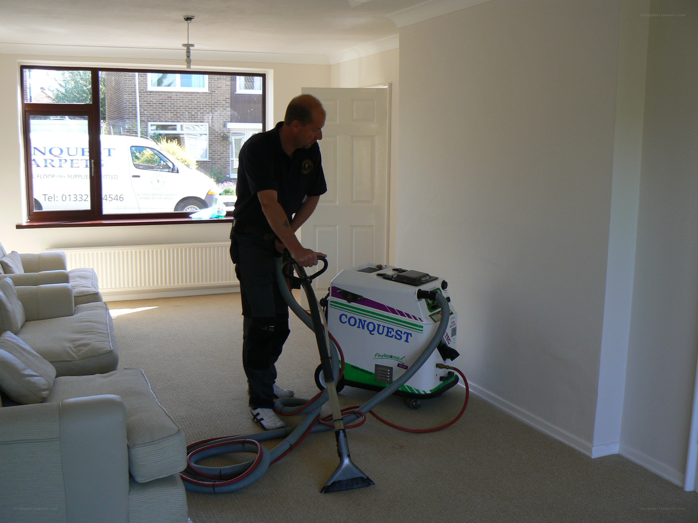 Man cleaning carpet with vacuum