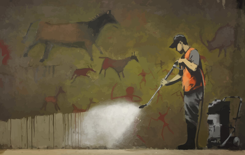 Man cleaning cave art
