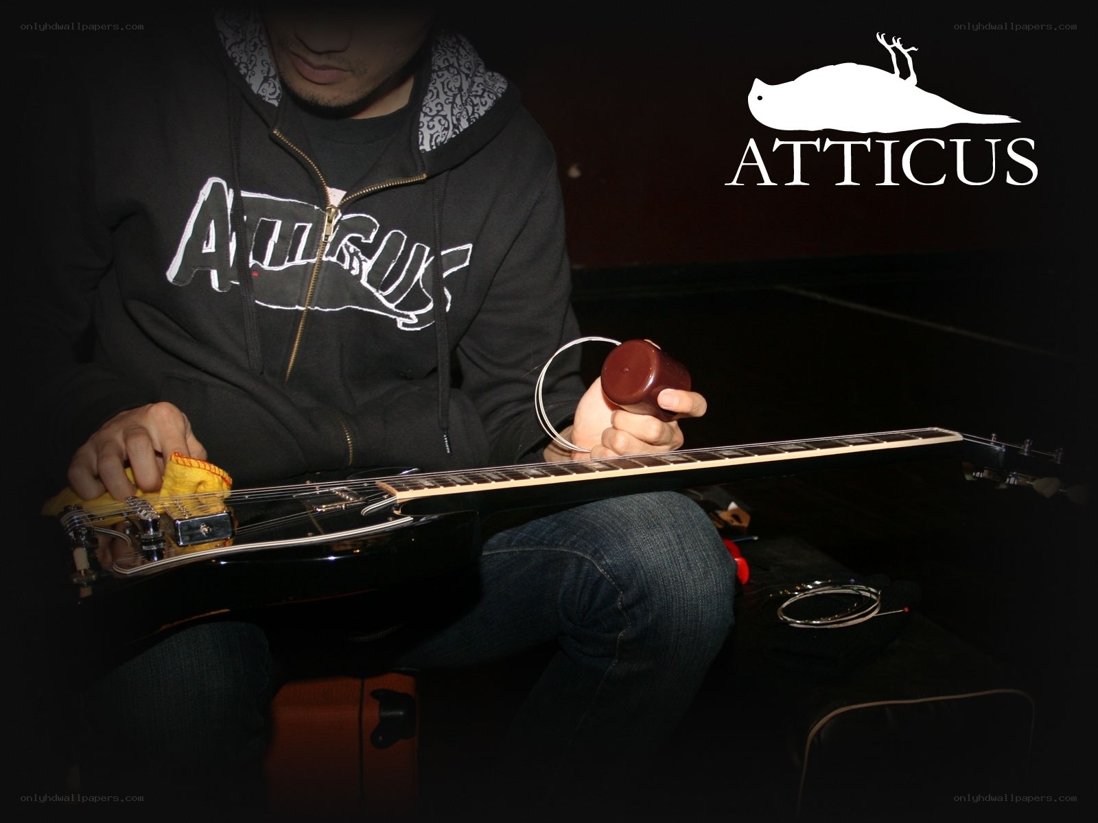 man cleaning electric guitar