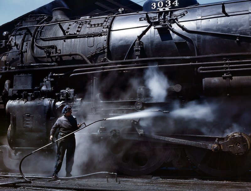Man cleaning steam locomotive