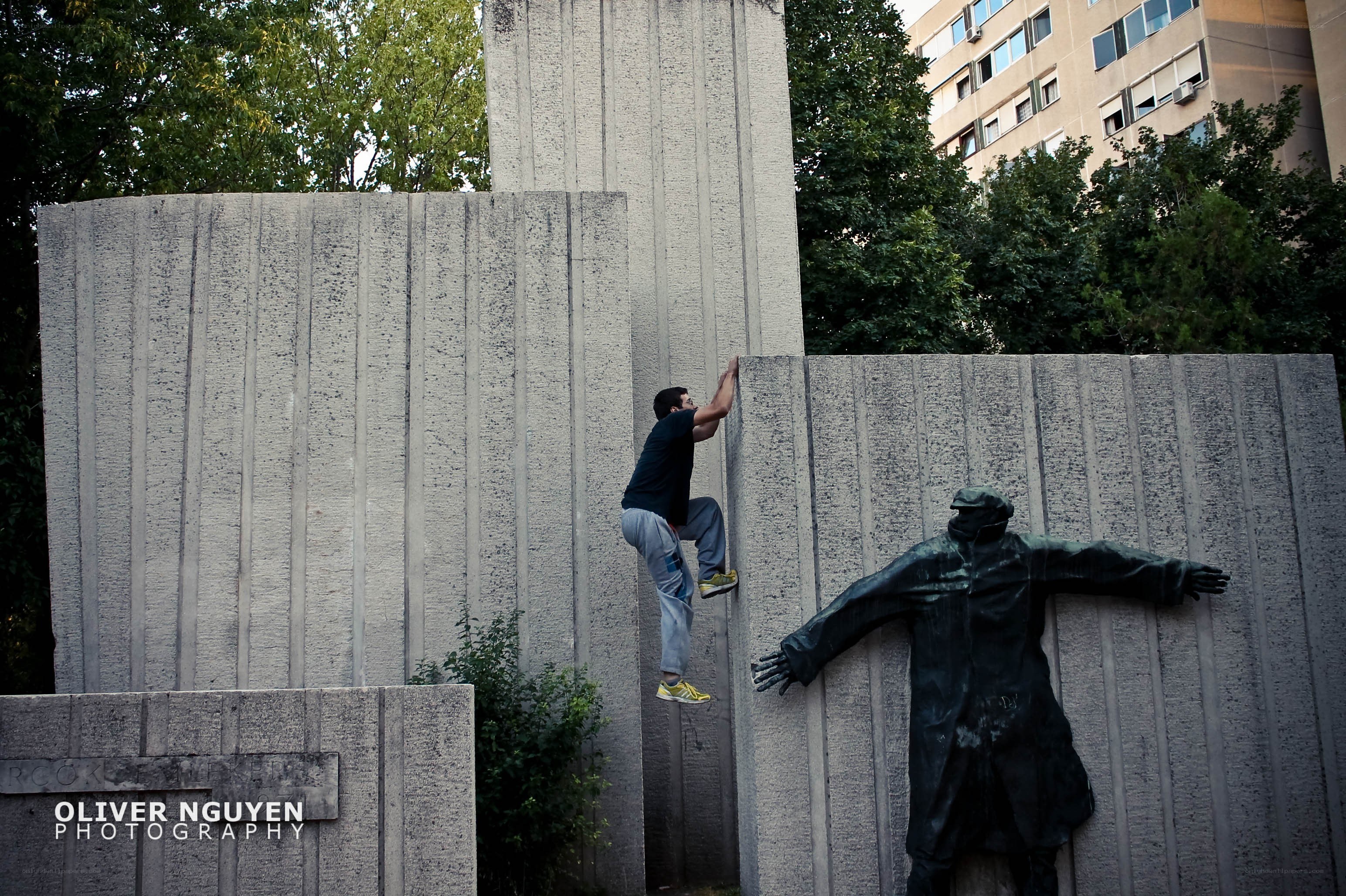 Man climbing concrete wall