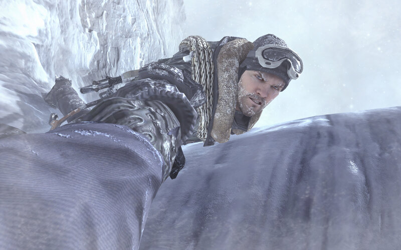man climbing icy cliff