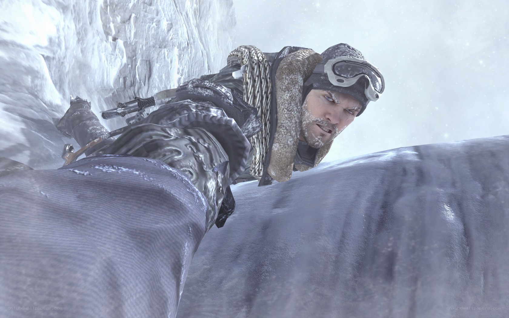 man climbing icy cliff