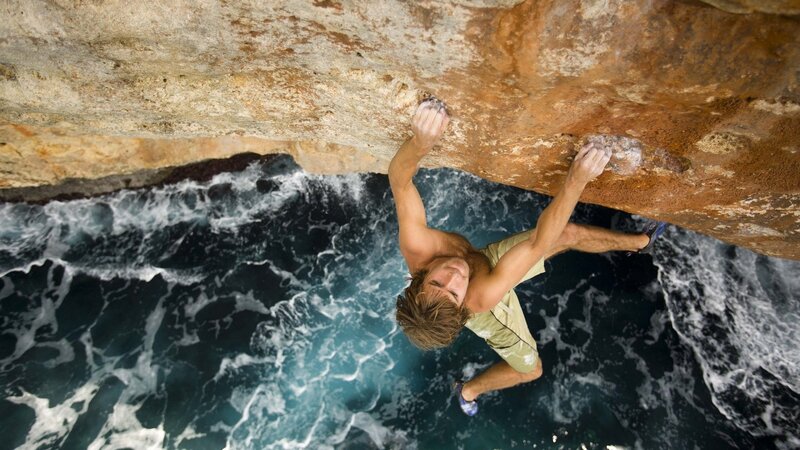 Man Climbing Rock — Brown, Dramatic