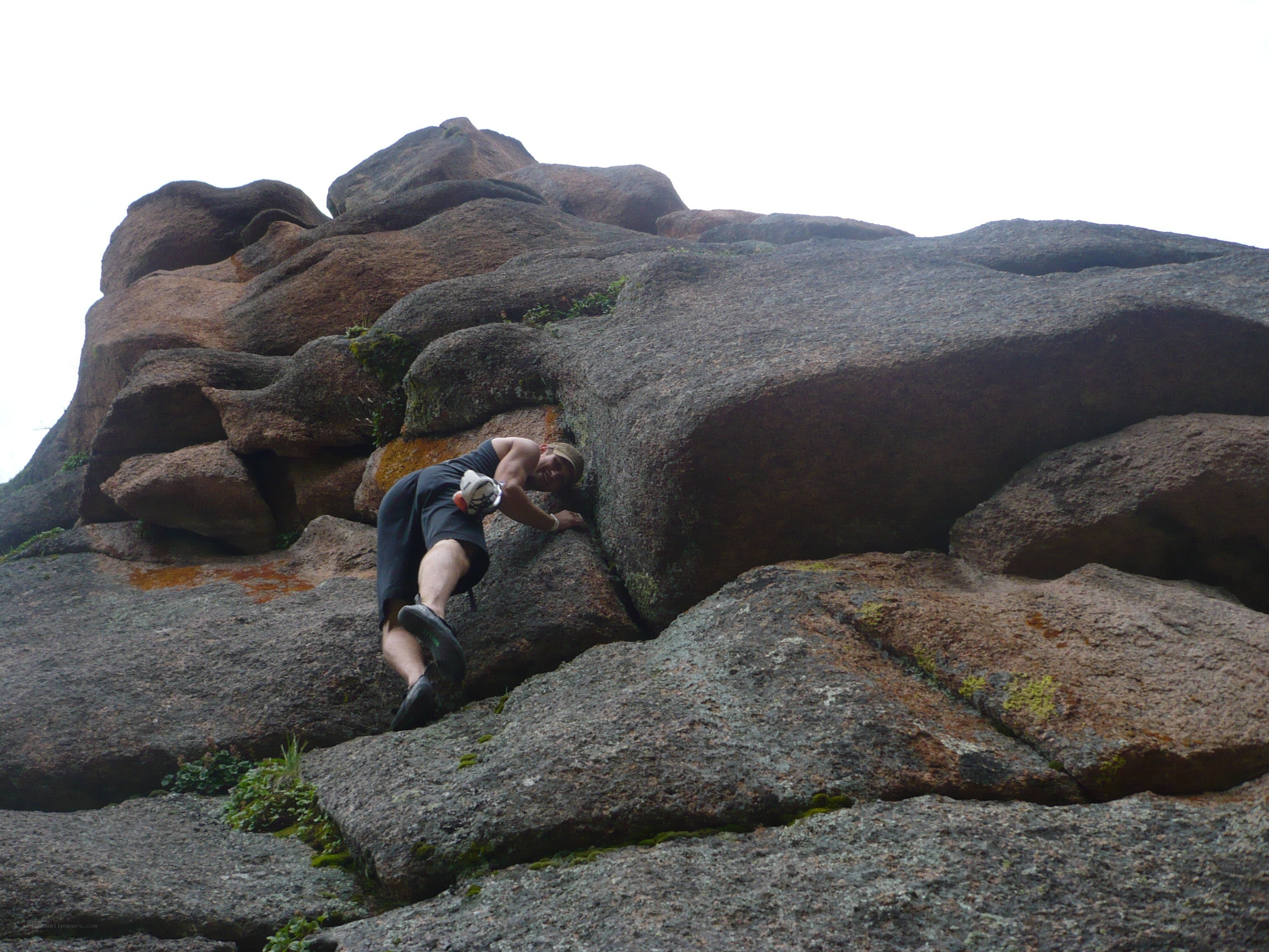 man climbing rocky terrain