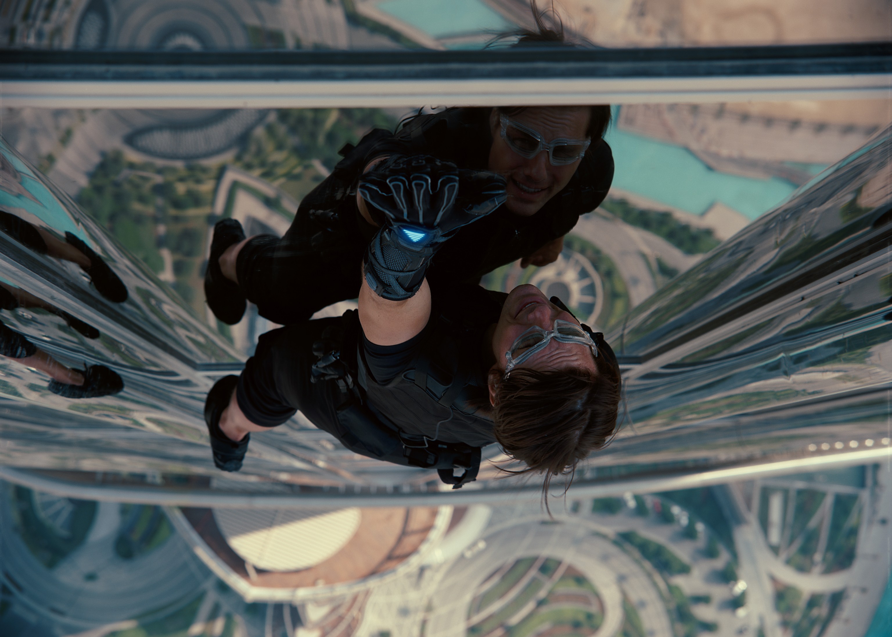 Man climbing skyscraper glass