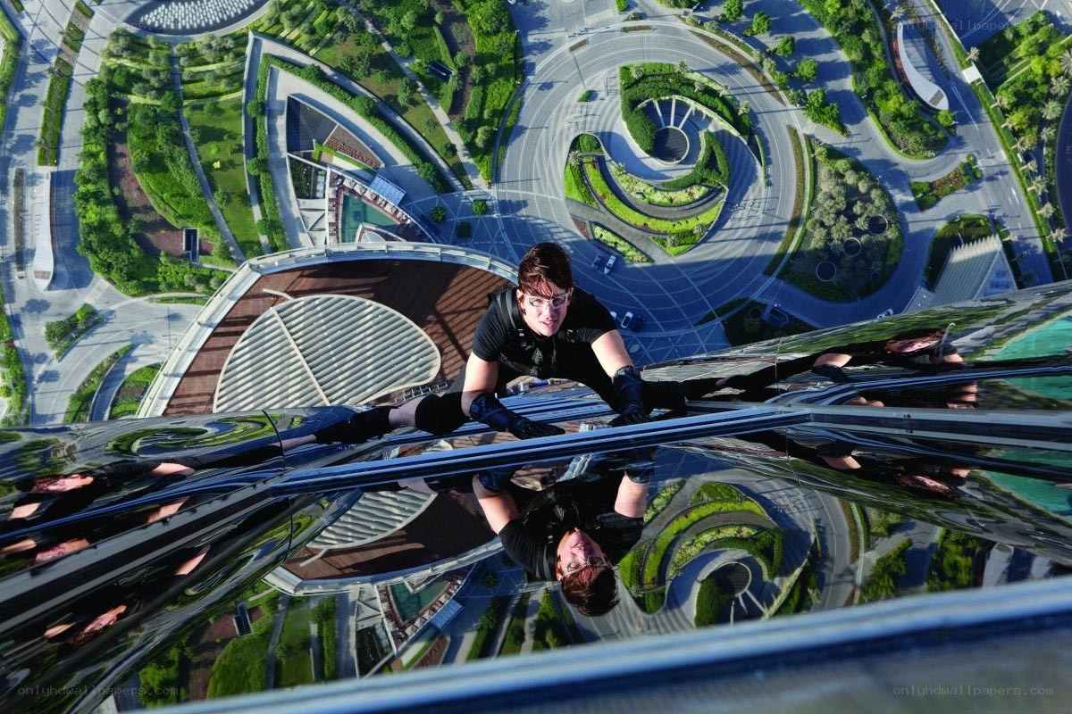 Man climbing skyscraper glass