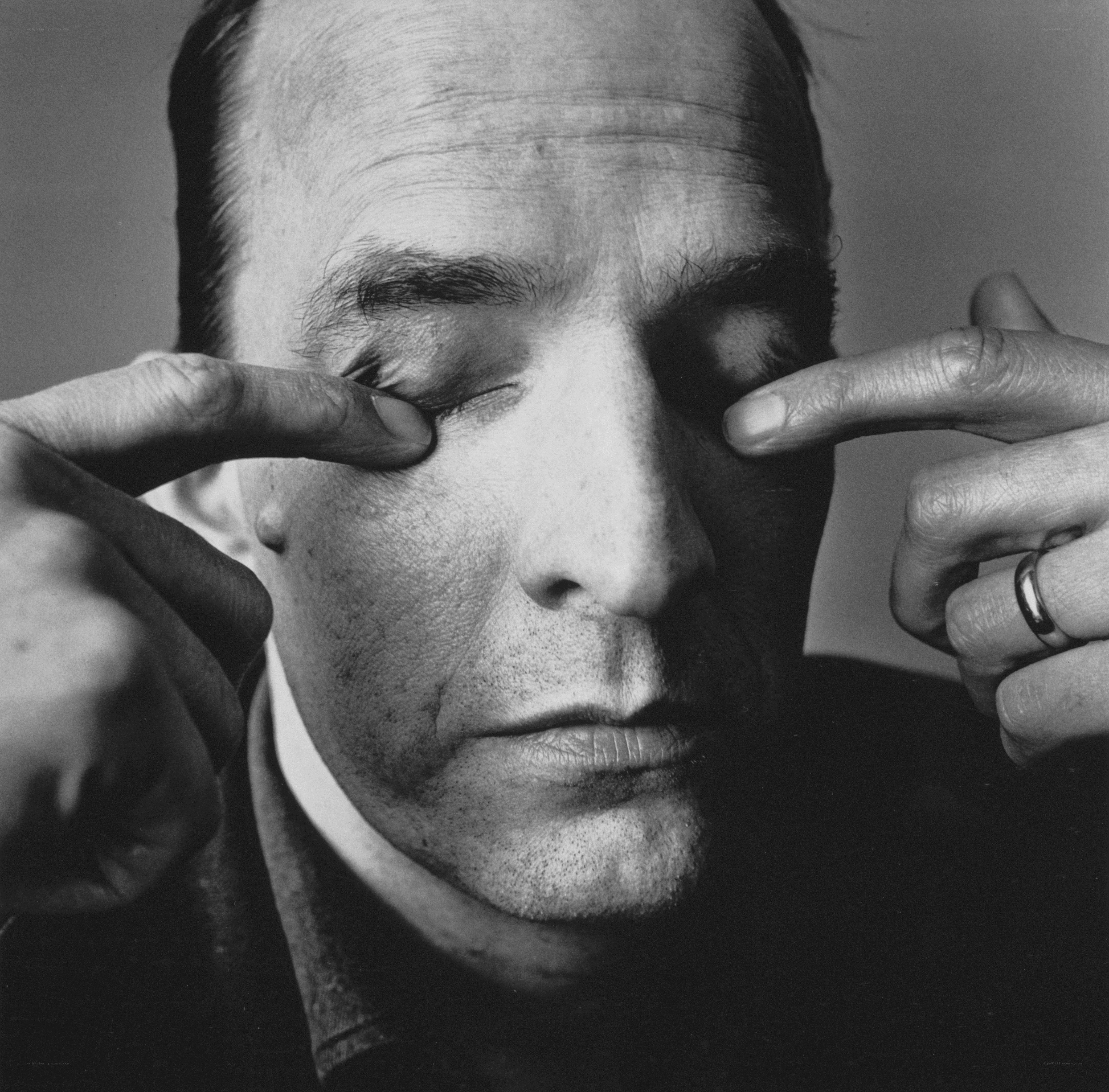 man closing eyes with fingers