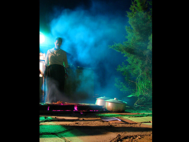Man cooking at night with smoke