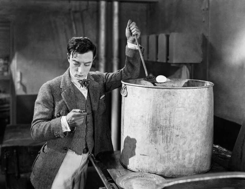 Man cooking egg in large pot