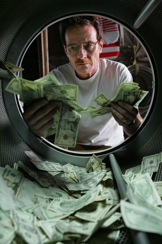 man counting money in dryer