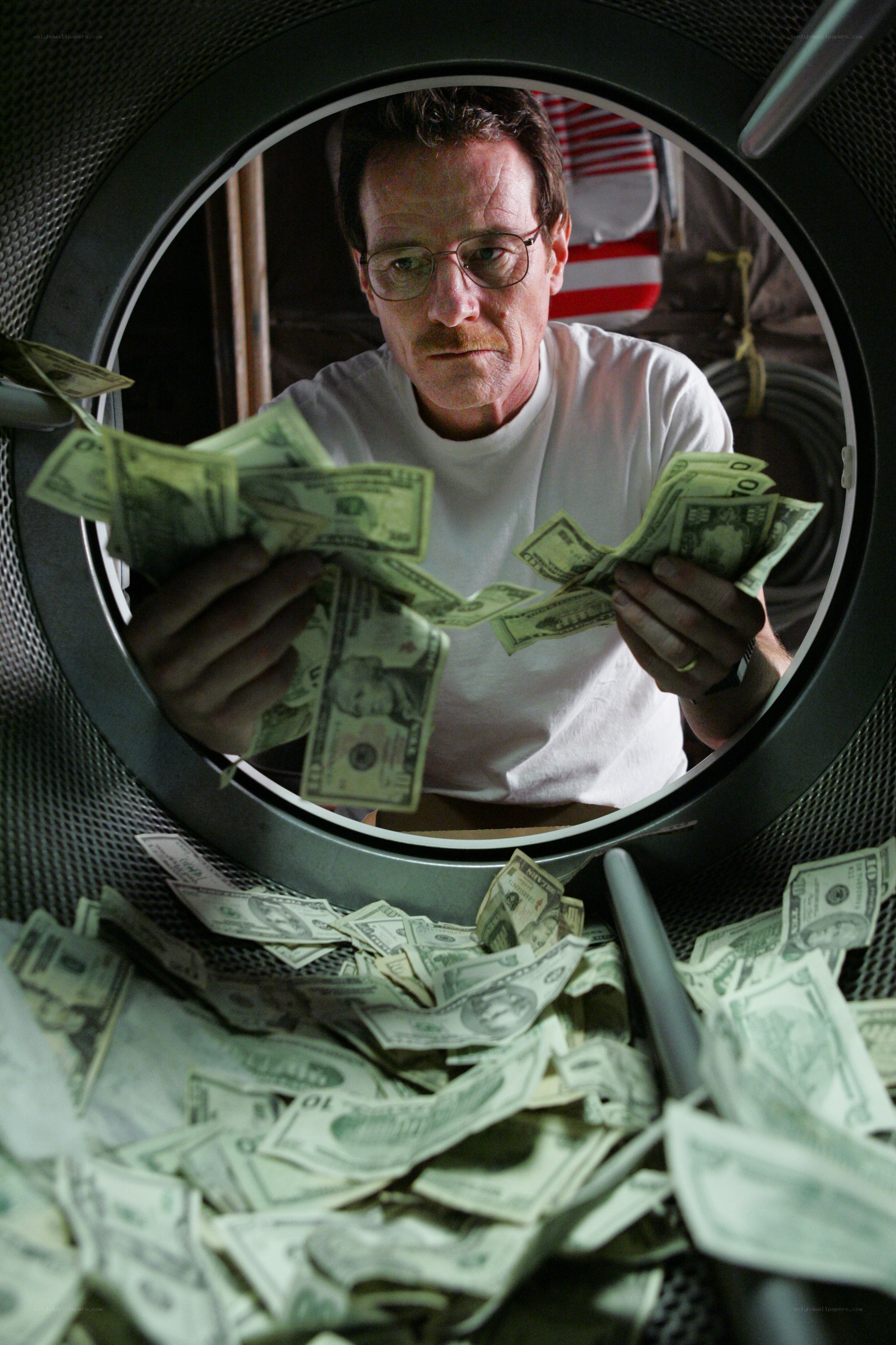 man counting money in dryer