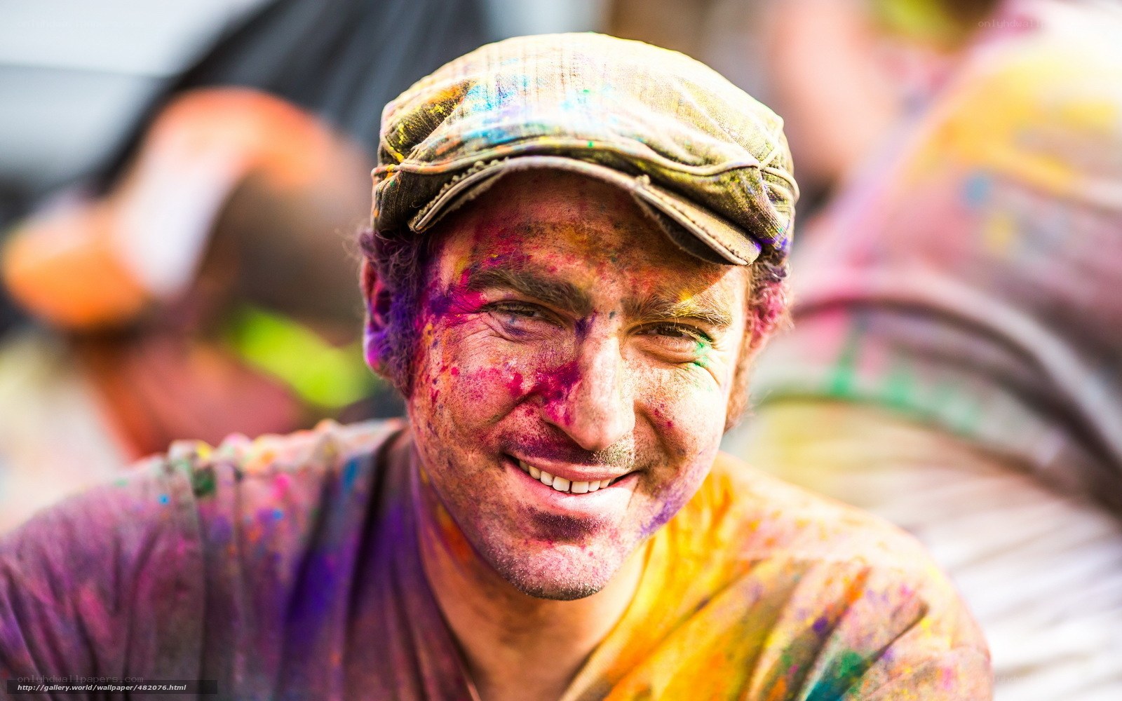 man covered in colorful powder