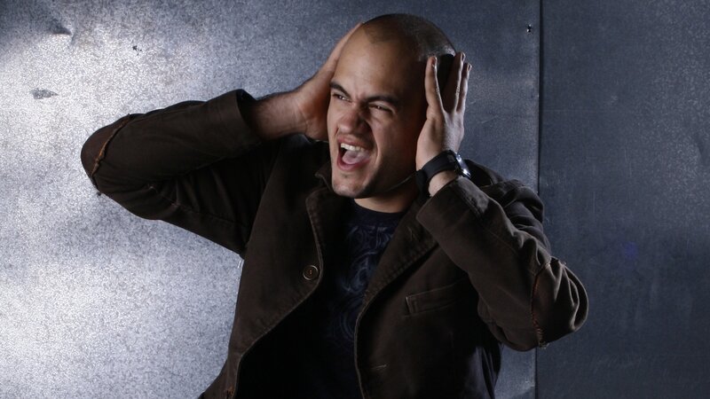 man covering ears in distress