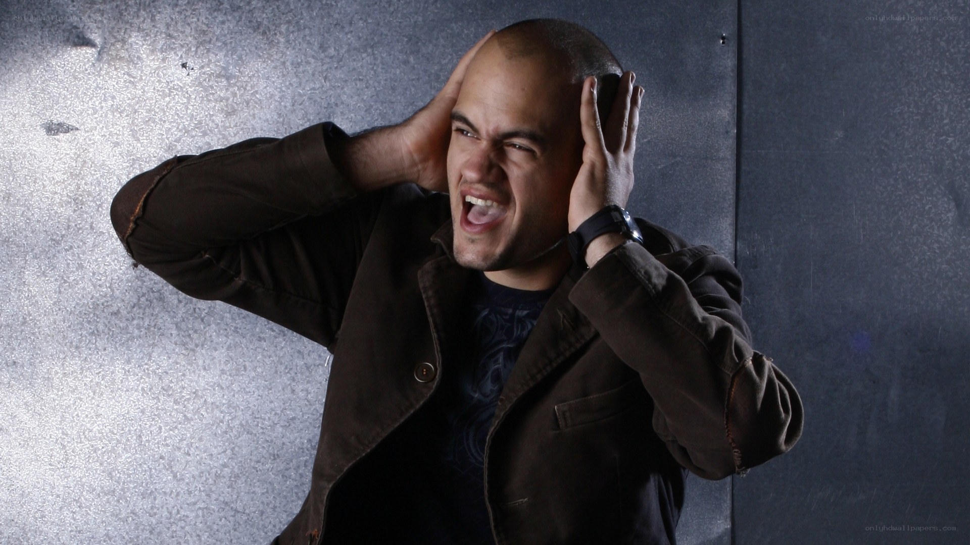 man covering ears in distress
