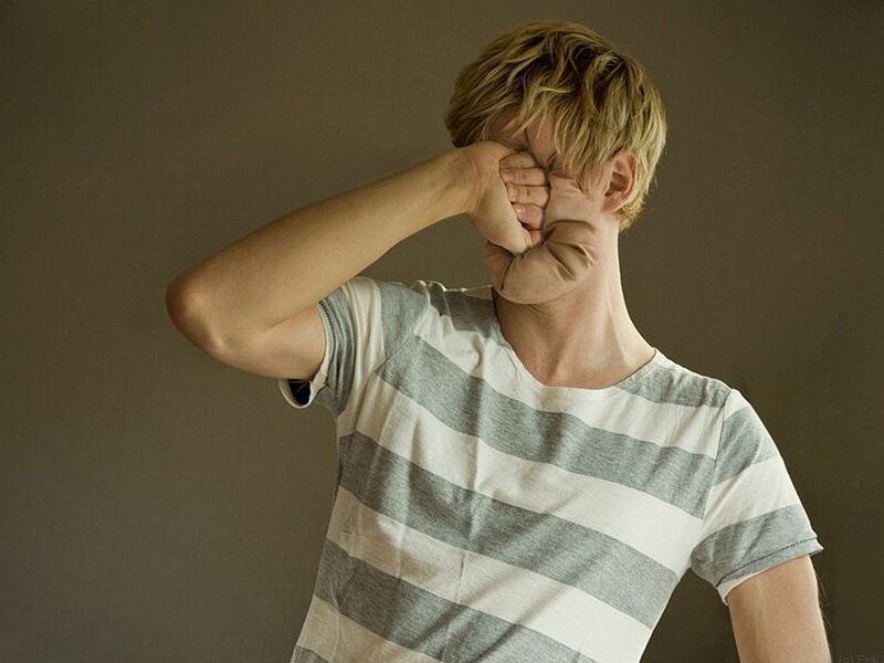 Man Covering Face