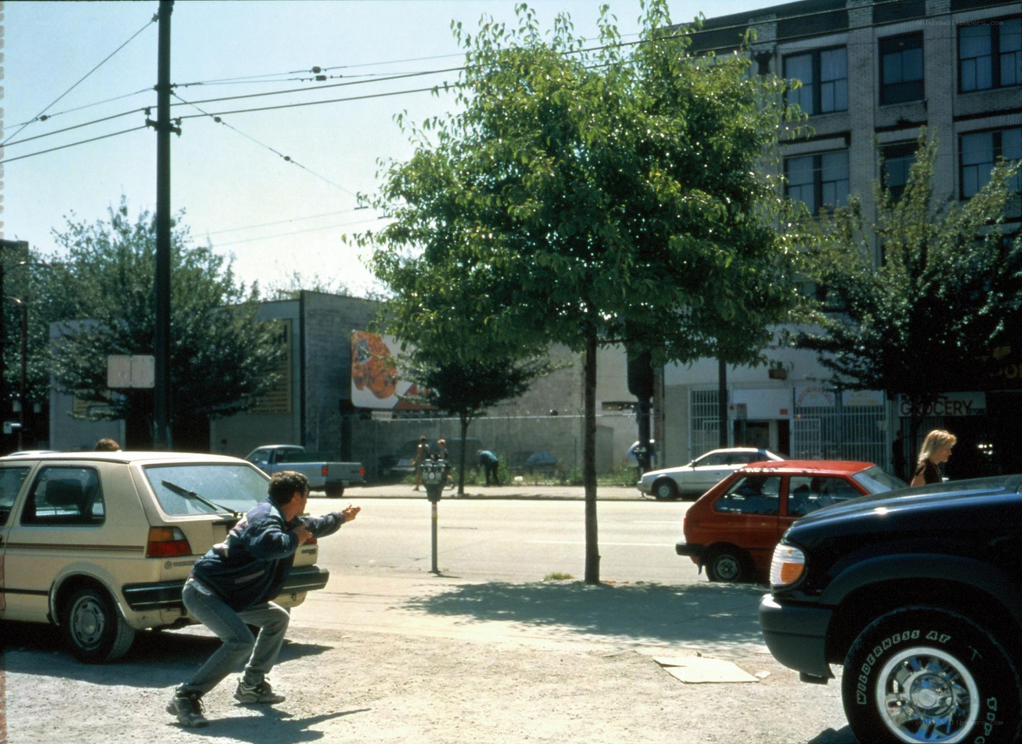 Man crouching on city street