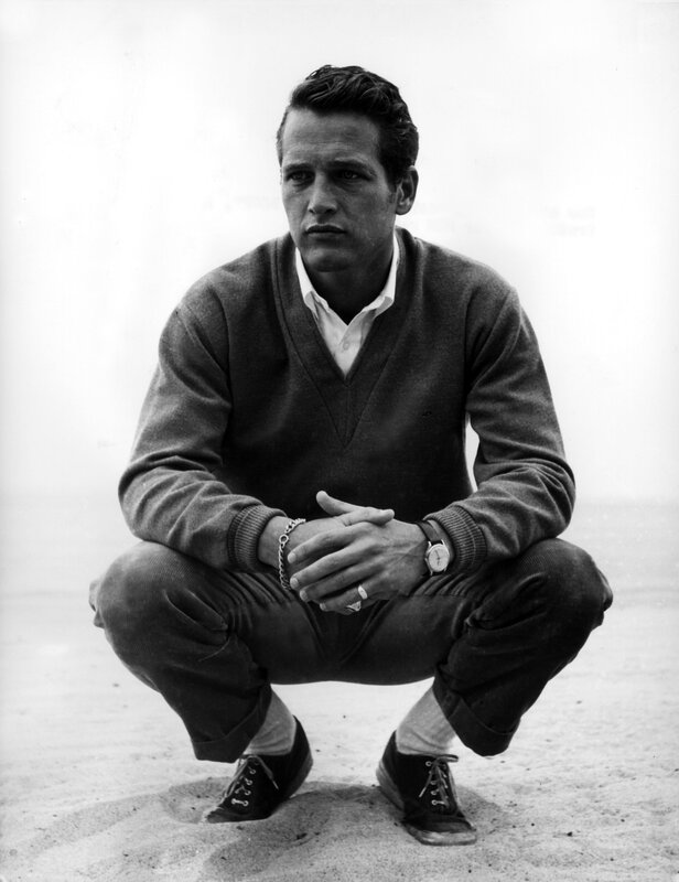 man crouching on sand