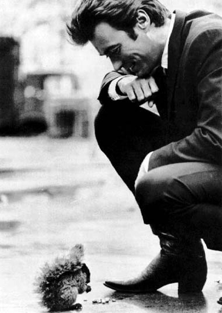 man crouching with squirrel