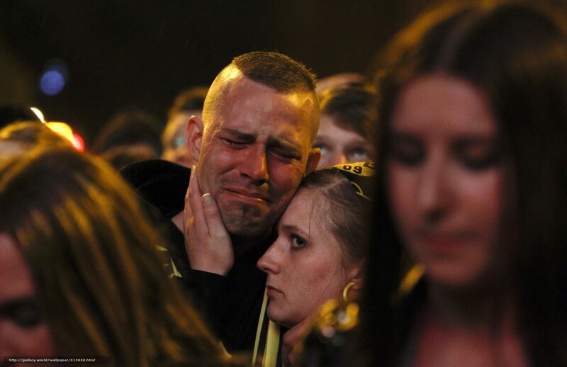 Man crying at a crowd
