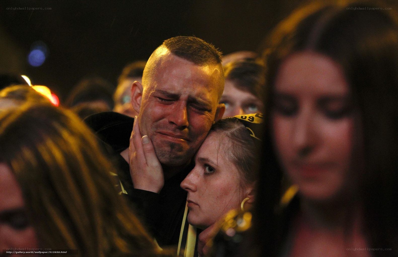 Man crying at a crowd