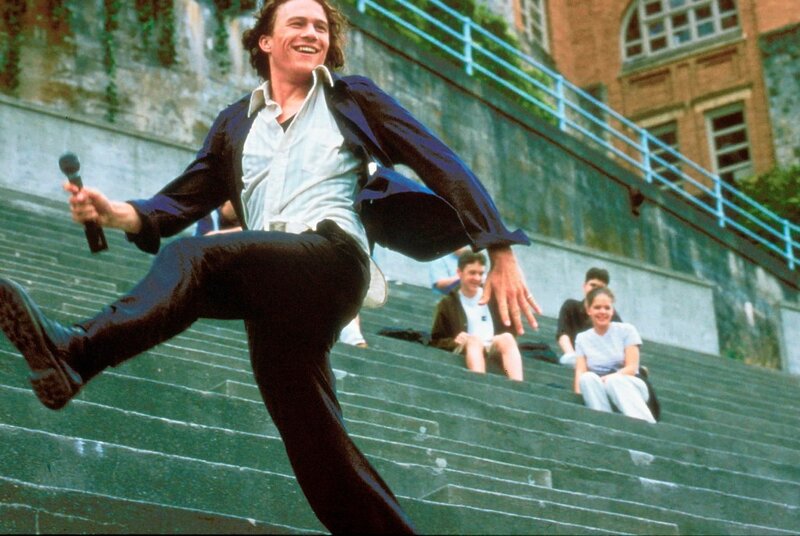Man dancing on stairs with microphone