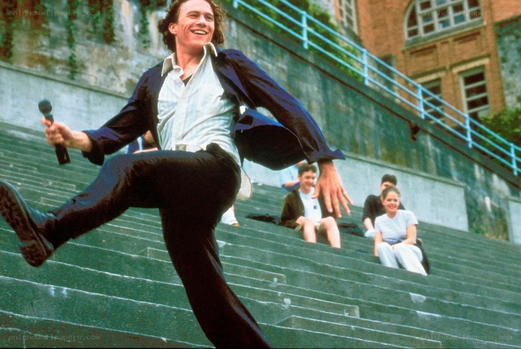 Man dancing on stairs with microphone