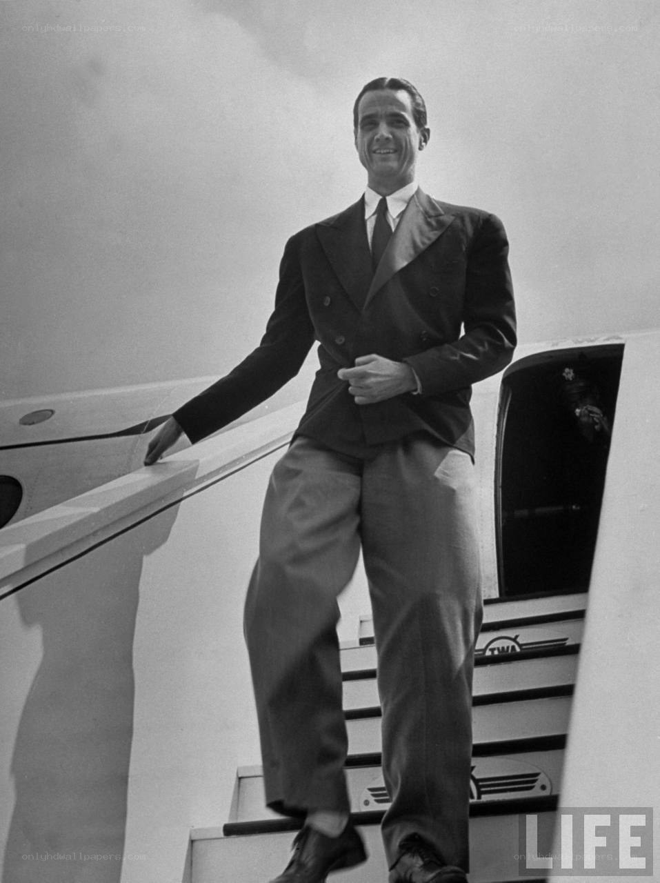 Man descending airplane stairs