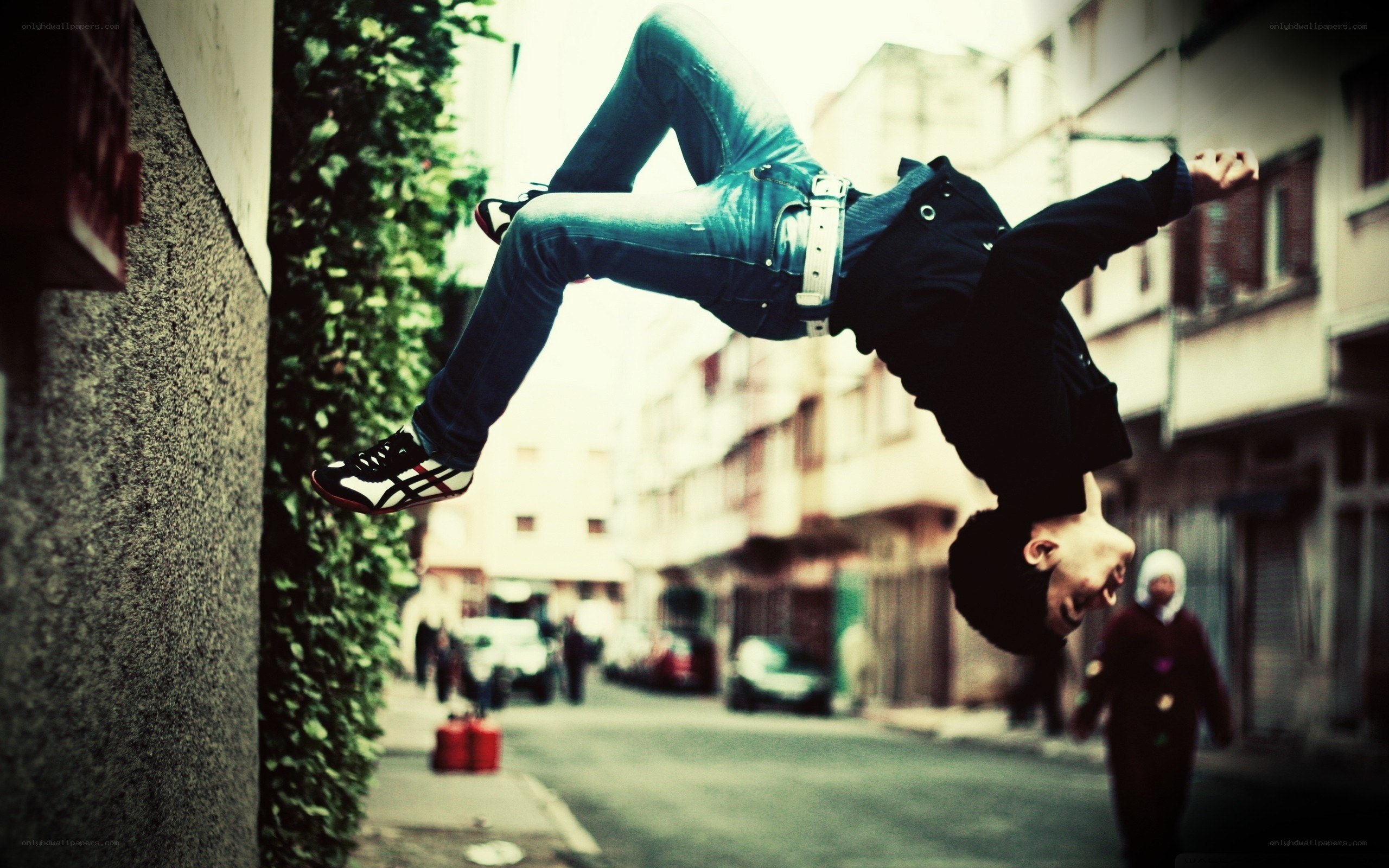 Man doing a backflip in the street
