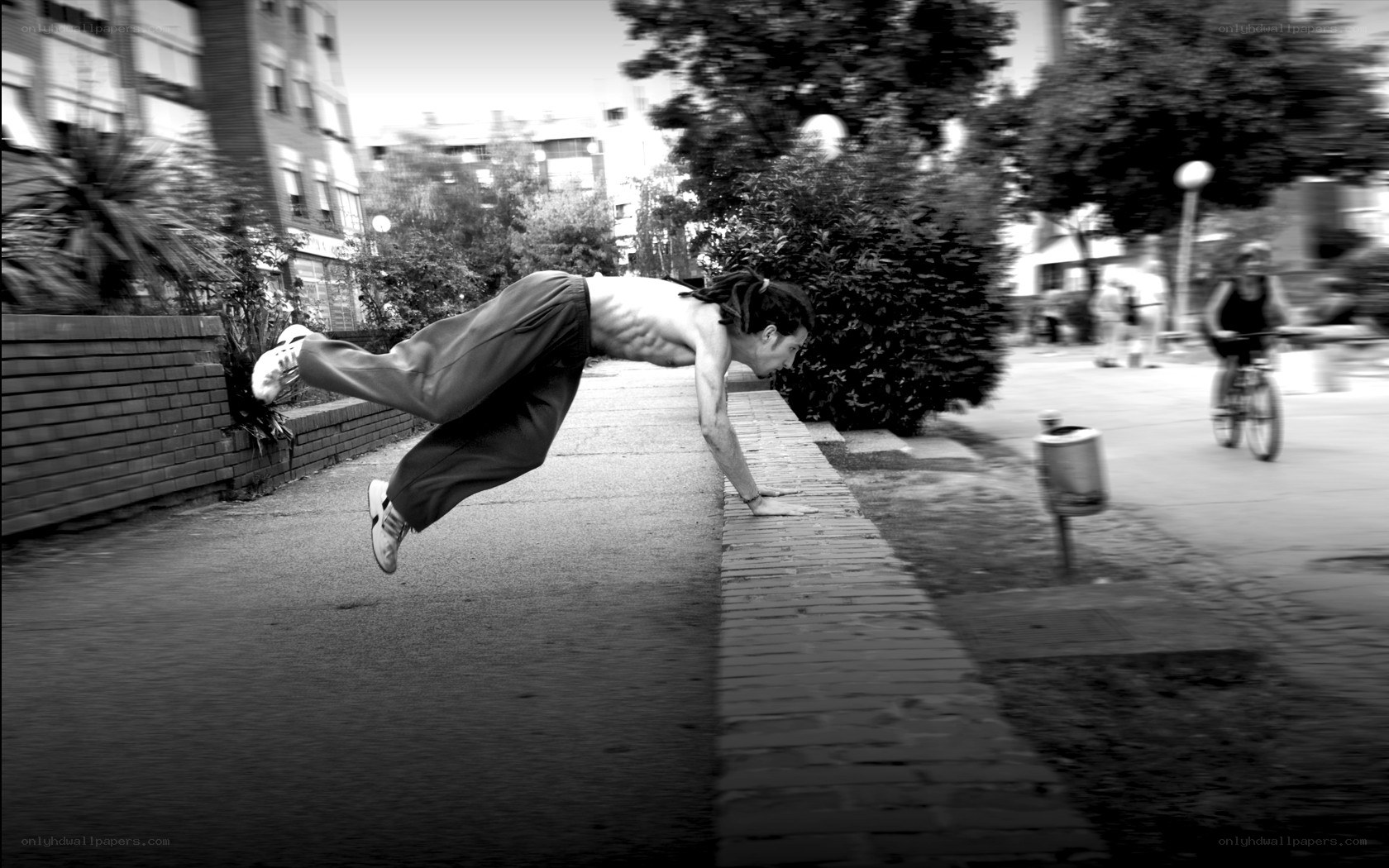 man doing acrobatic move on sidewalk