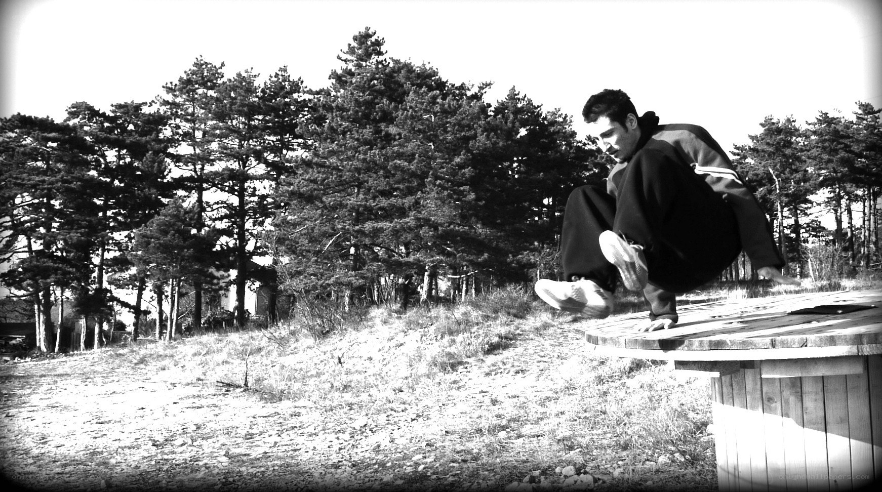 man doing parkour on a barrel