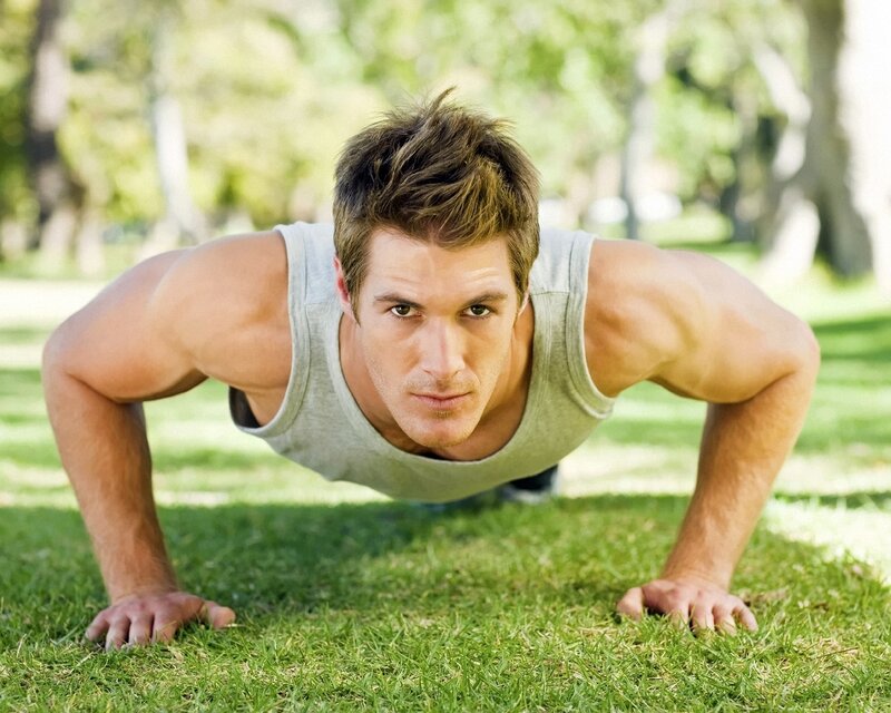 man doing push-ups in park